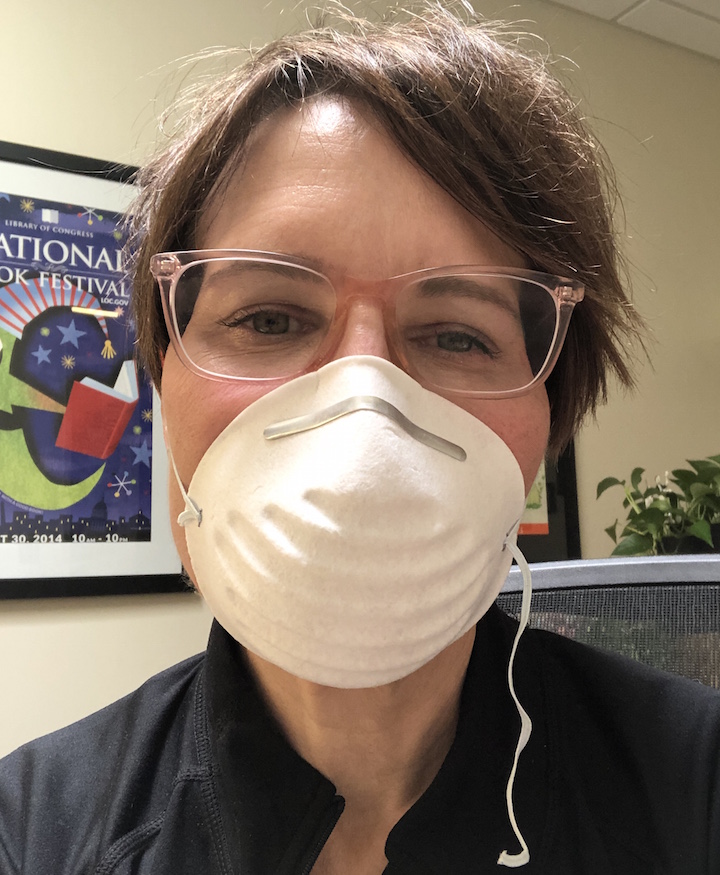 Librarian wears mask.