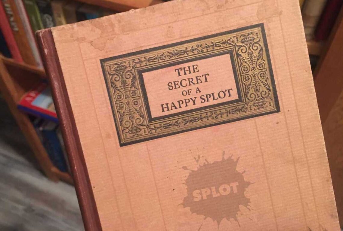 An old book cover with embossed title-- The Secret of a Happy SPLOT